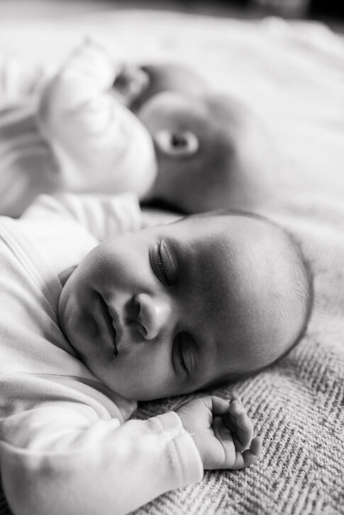 Neugeborenes schläft neben Drillingsbaby bei Newbornshooting
